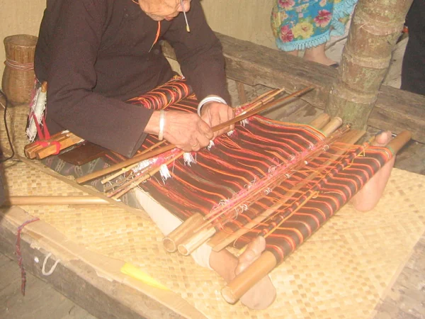 A craftsperson demonstrating traditional Chinese weaving skills associated with Qixi A craftsperson demonstrating traditional Chinese weaving skills associated with Qixi