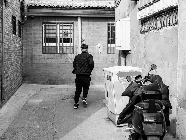 Travelers exploring a Beijing neighborhood in winter