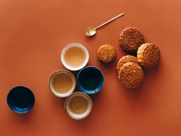 Traditional Chinese mooncakes arranged with tea on a table Traditional Chinese mooncakes arranged with tea on a table