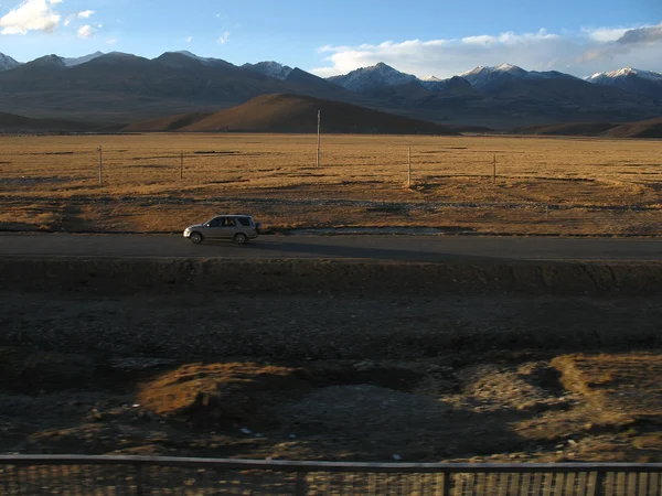 Paved highway crossing plateau terrain near Lhasa Paved highway crossing plateau terrain near Lhasa