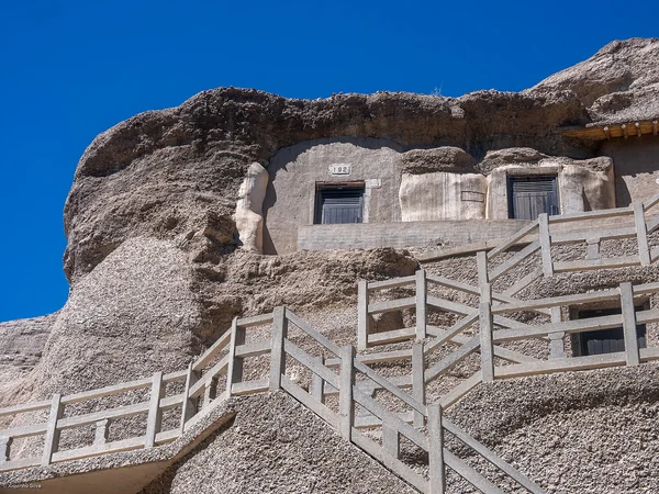Cliff face and visitor walkway at the Mogao Caves near Dunhuang