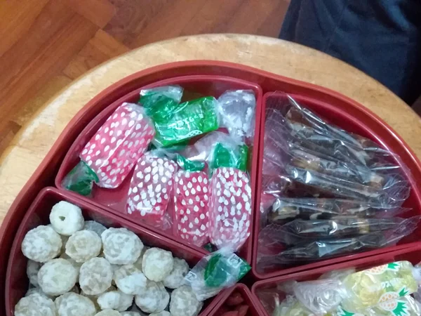 A colorful tray of wrapped sweets for Chinese New Year guests A colorful tray of wrapped sweets for Chinese New Year guests