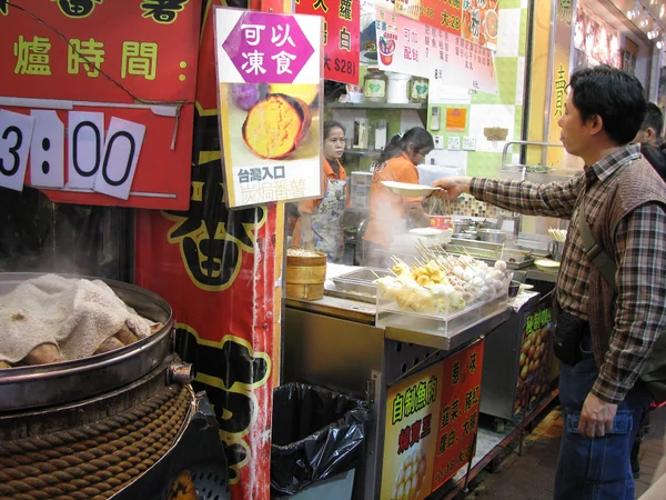 A food stall serving customers at a traditional market A food stall serving customers at a traditional market