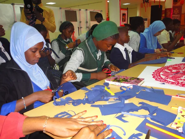 Participants working together on colorful paper-cutting crafts Participants working together on colorful paper-cutting crafts