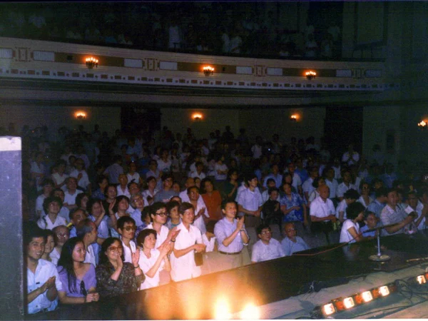 Audience members watching a live performance in a Chinese theatre Audience members watching a live performance in a Chinese theatre