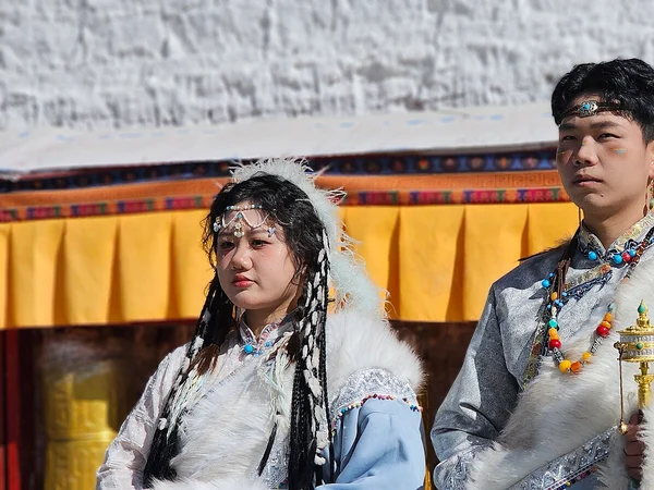 Tibetan people wearing regional chuba and festival clothing