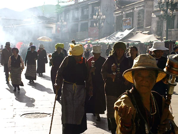 Pilgrims following a sacred walking route near Jokhang Temple