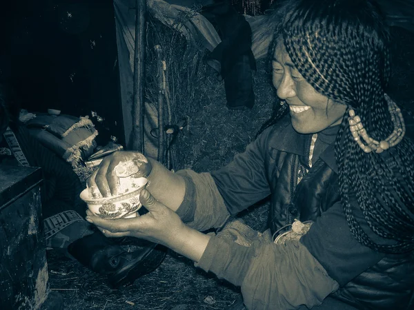 Roasted barley flour being prepared as Tibetan tsampa