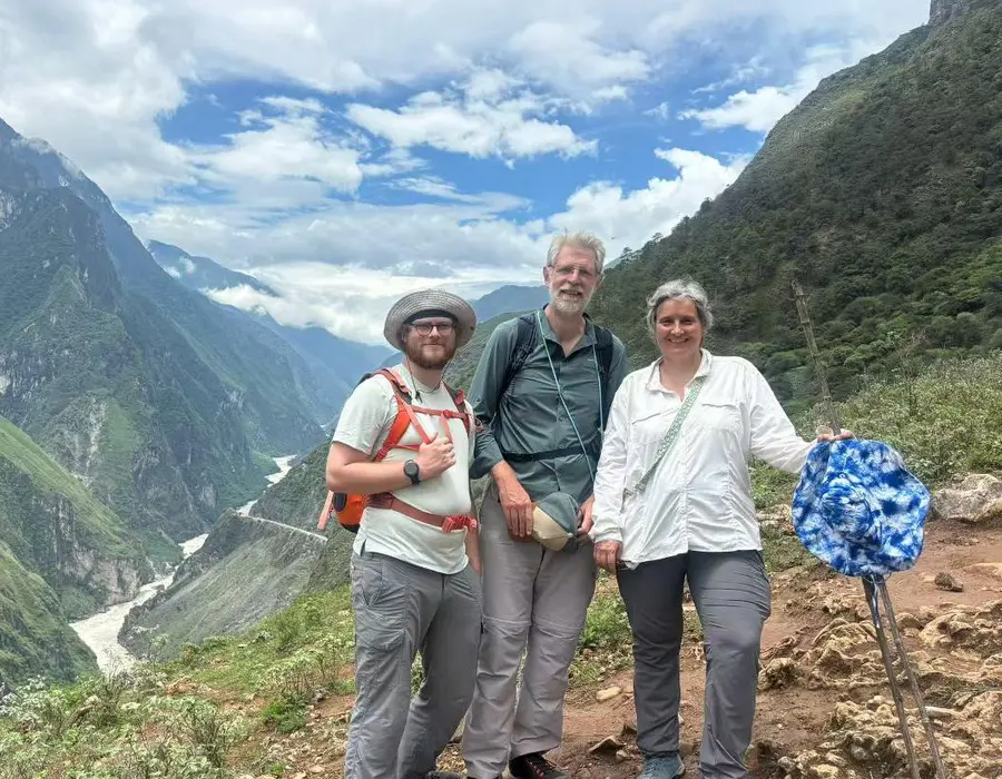 Travelers standing together in a dramatic mountain valley in China