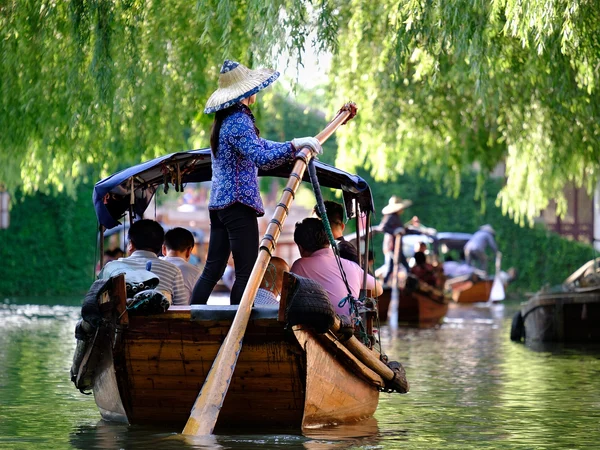 Visitors walking beside a canal in a Jiangnan water town
