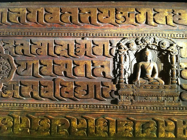 Tibetan artisan carving a wooden panel Tibetan artisan carving a wooden panel