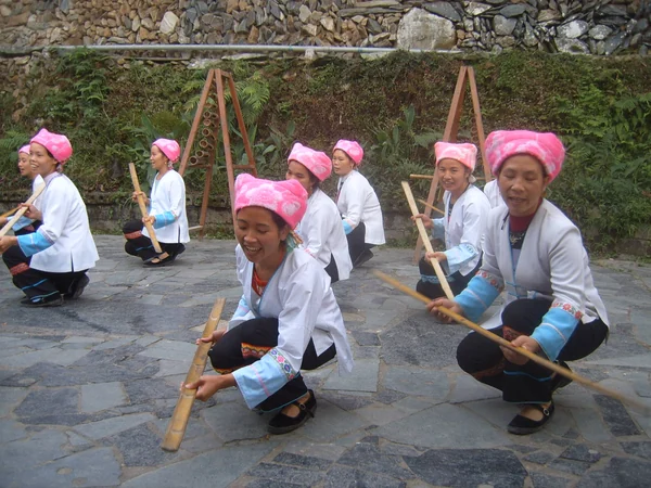 Zhuang performers in traditional dress during a cultural dance Zhuang performers in traditional dress during a cultural dance