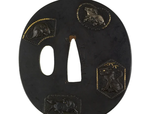 A Japanese sword guard decorated with animals from the Chinese zodiac