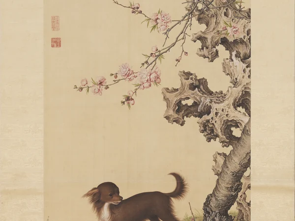A Chinese painting of a dog beneath flowering branches