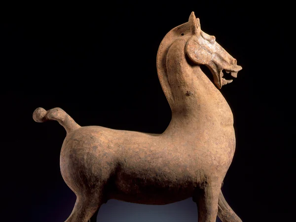 A Chinese funerary horse sculpture in a museum collection A Chinese funerary horse sculpture in a museum collection