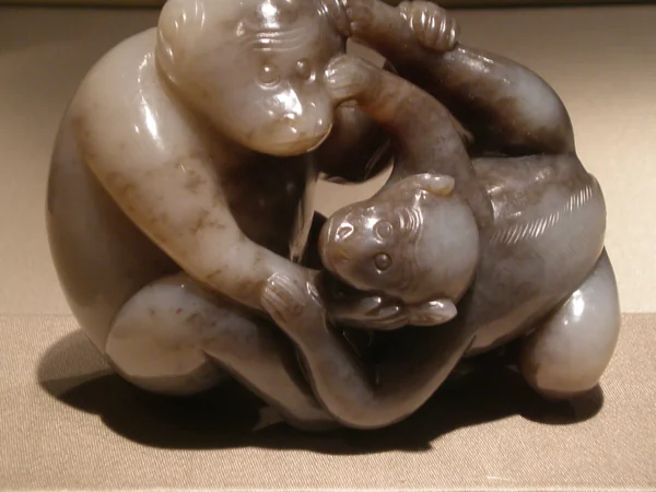 Two monkeys wrestling in a Chinese sculpture Two monkeys wrestling in a Chinese sculpture