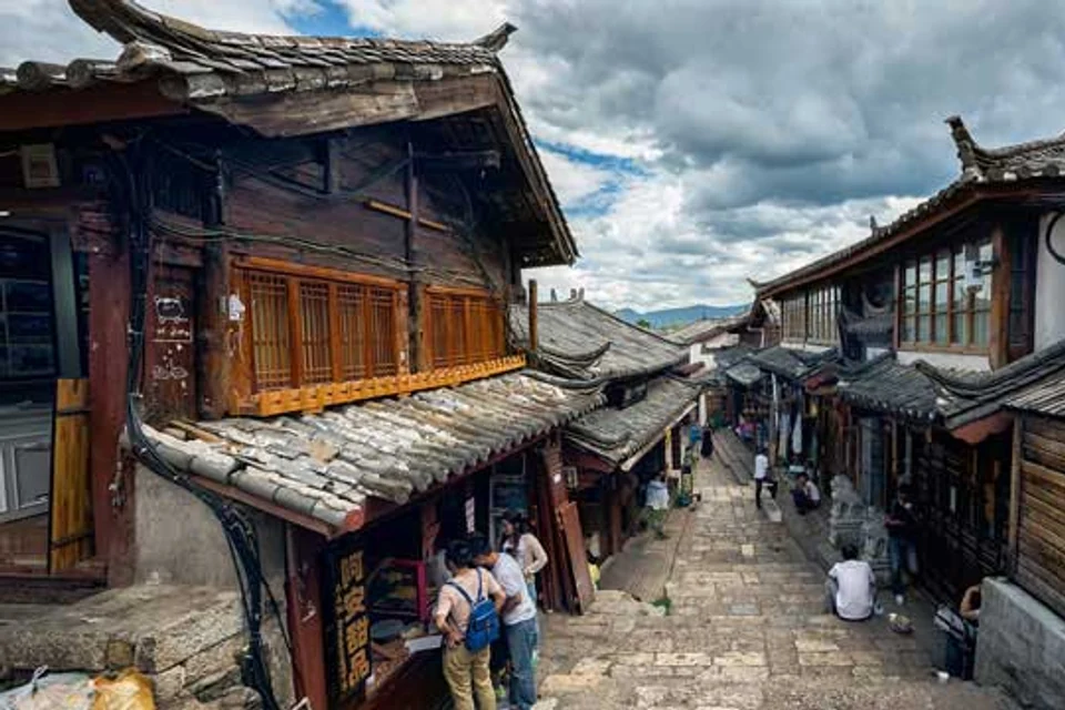 Stone lane lined with wooden houses in Lijiang Old Town
