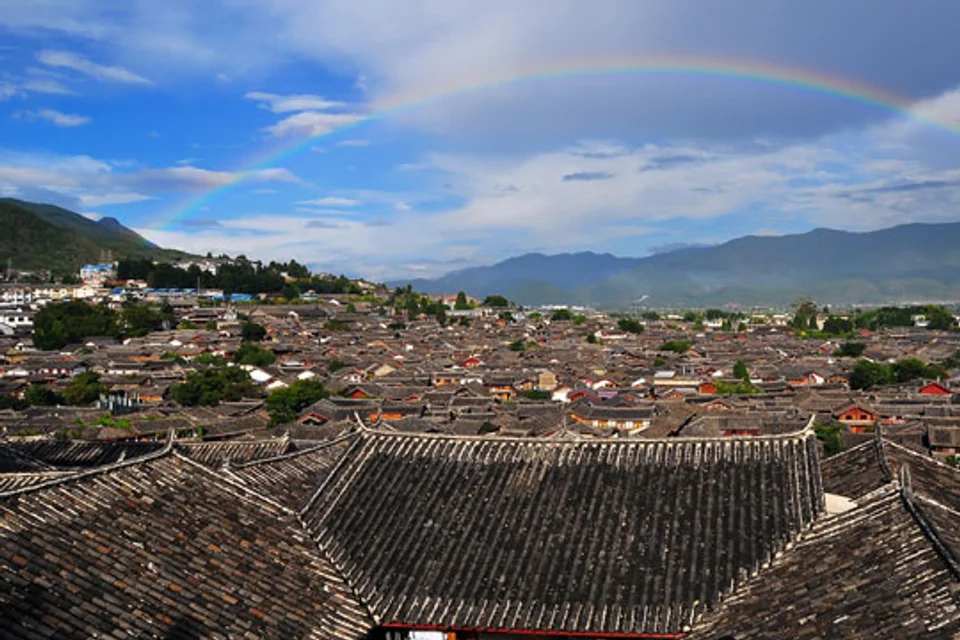 Rainbow arching over the rooftops of Lijiang Old Town