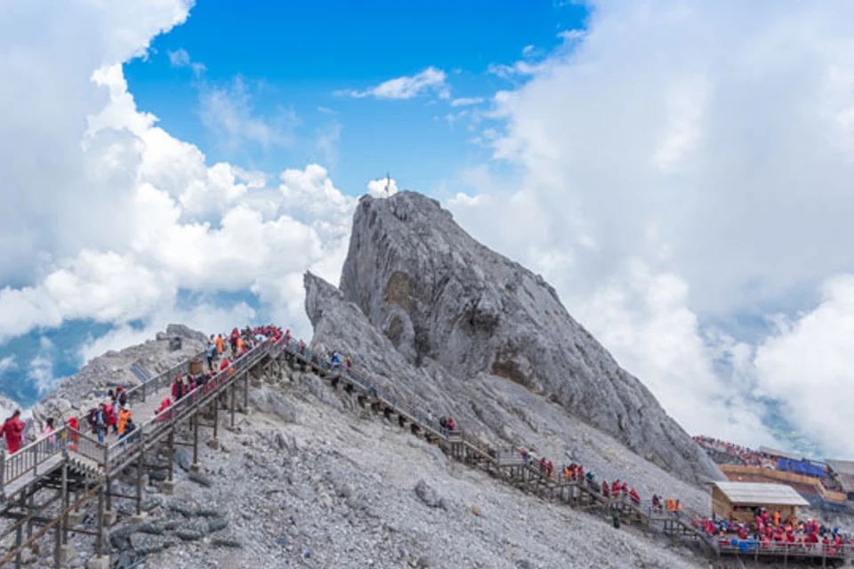 Visitors walking on the high-altitude trail at Jade Dragon Snow Mountain
