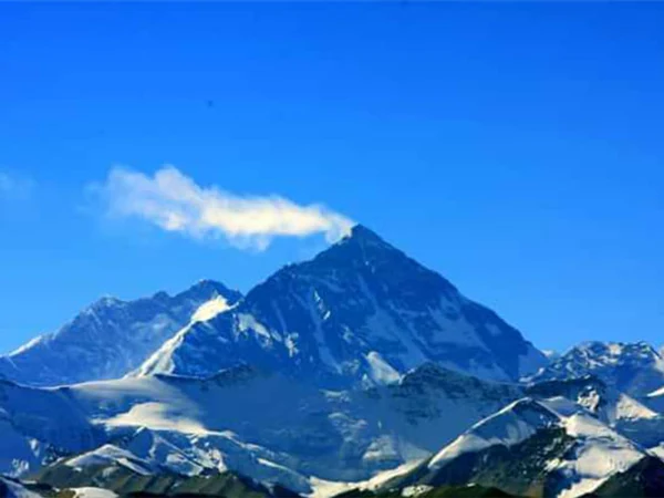 Snow-covered Mount Everest beneath a clear blue sky