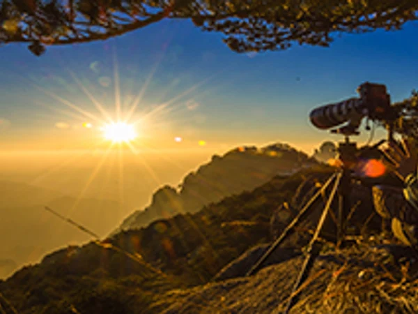 Travel photographer capturing a mountain sunrise in China