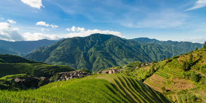 Longji rice terraces, mountain forest and village landscape Longji rice terraces, mountain forest and village landscape