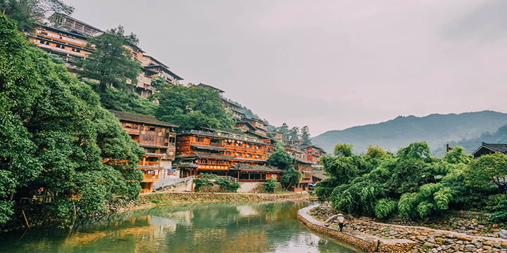 Timber houses and riverfront landscape in Xijiang Timber houses and riverfront landscape in Xijiang
