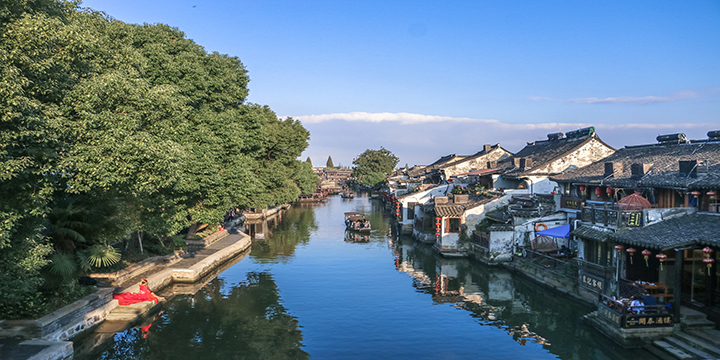Traditional bridge and tiled waterfront buildings in Xitang Ancient Town Traditional bridge and tiled waterfront buildings in Xitang Ancient Town