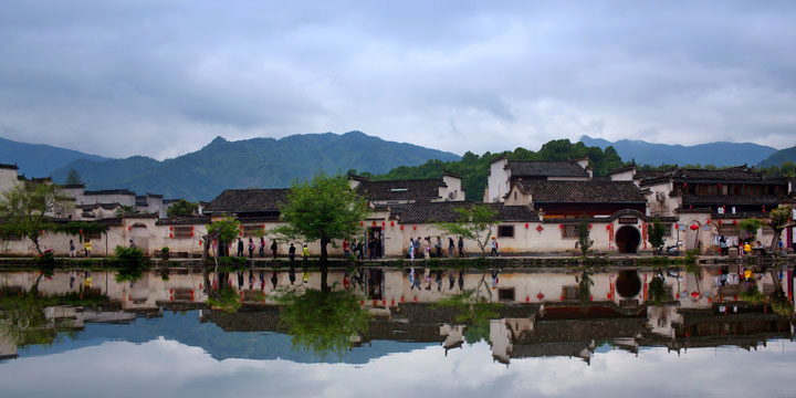 Hui-style houses and calm water reflections in Hongcun Village Hui-style houses and calm water reflections in Hongcun Village
