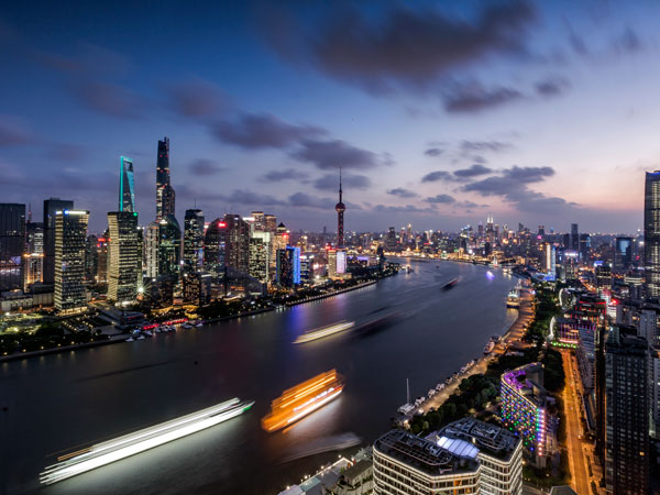 Shanghai skyline and Huangpu River at dusk