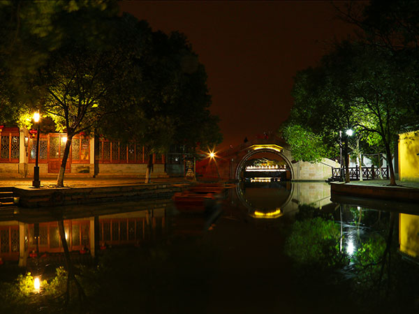 Illuminated canal bridge and waterside buildings in Zhouzhuang at night Illuminated canal bridge and waterside buildings in Zhouzhuang at night