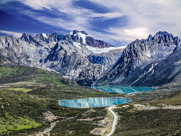 High-altitude lake and rugged snowy peaks in Tibet during winter High-altitude lake and rugged snowy peaks in Tibet during winter