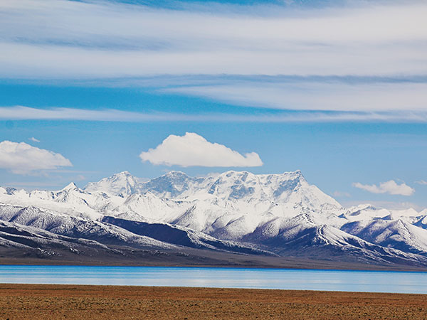 Snow-covered mountain range across the Tibetan Plateau in winter