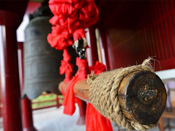 Wooden prayer wheel beside red monastery decoration in Tibet Wooden prayer wheel beside red monastery decoration in Tibet